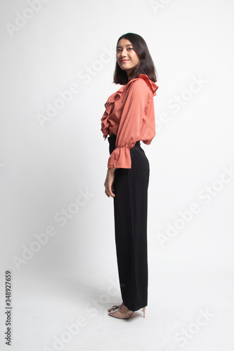 Full body side view of beautiful young asian woman .