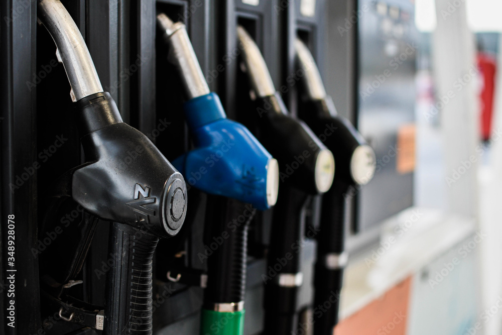 Man hanging the gas station hose after filling gasoline
Man hanging the gas station hose after filling gasoline