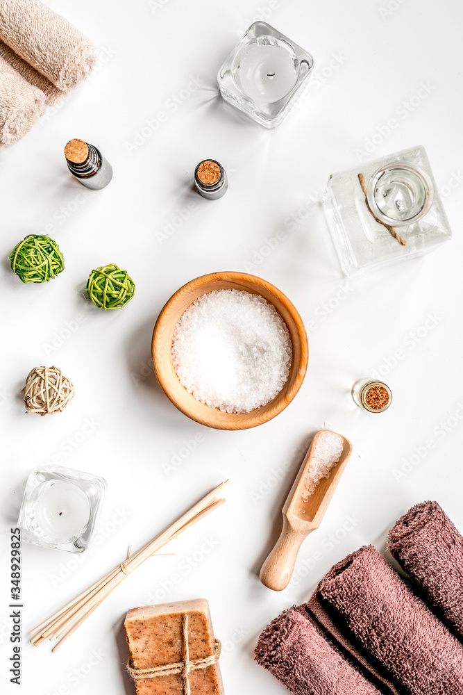 spa cosmetics with soap, salt, oil on white background top view spa cosmetics with soap, salt, oil on white background top view