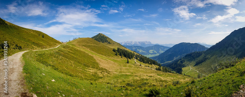 Beautiful alpine panorama scenery near in Kitzbuhel, Tirol. Austrian Alps landscape with a green summer valley and the Wilder Kaiser mountain range in the background.