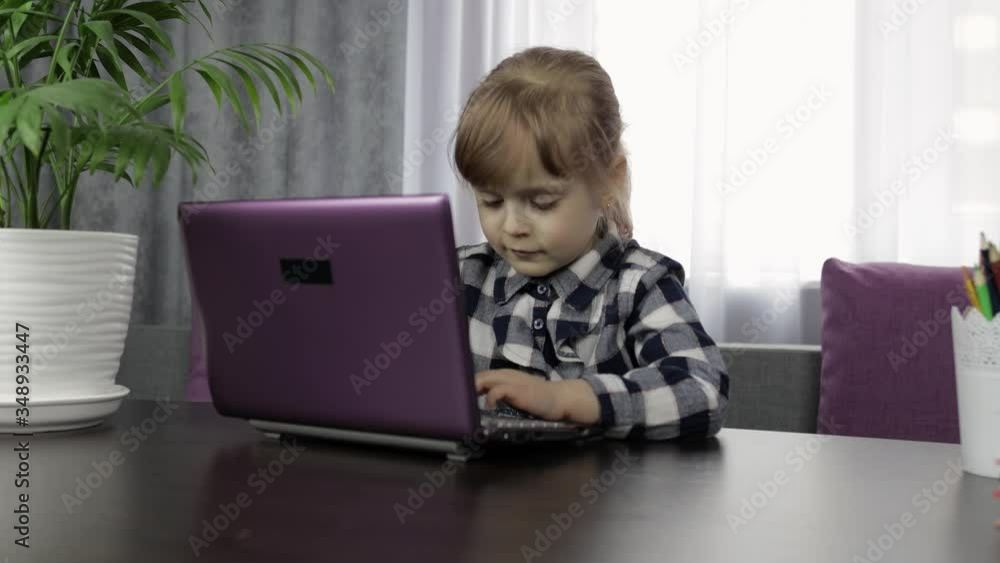 Girl doing online homework using digital laptop computer. Distance education Girl doing online homework using digital laptop computer. Distance education