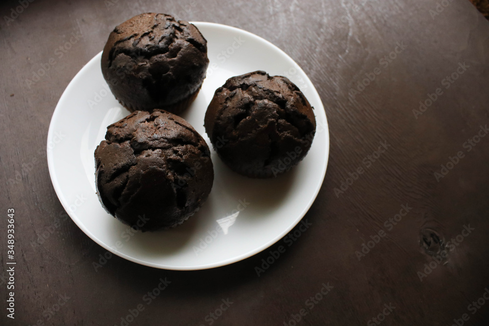Chocolate cupcakes on a white plate Chocolate cupcakes on a white plate