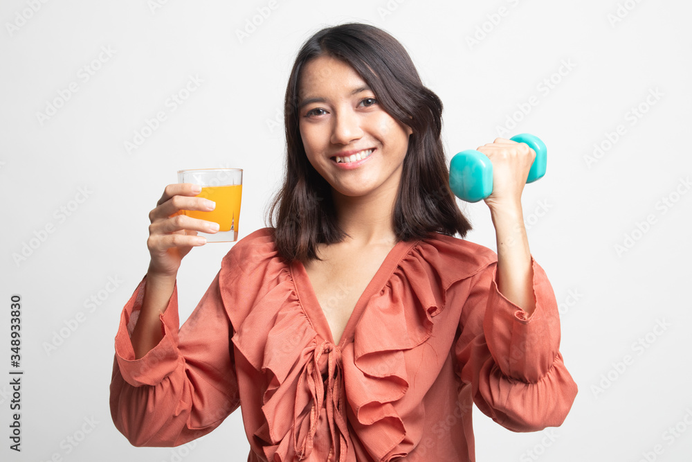 Young Asian woman with dumbbell drink orange juice . Young Asian woman with dumbbell drink orange juice .