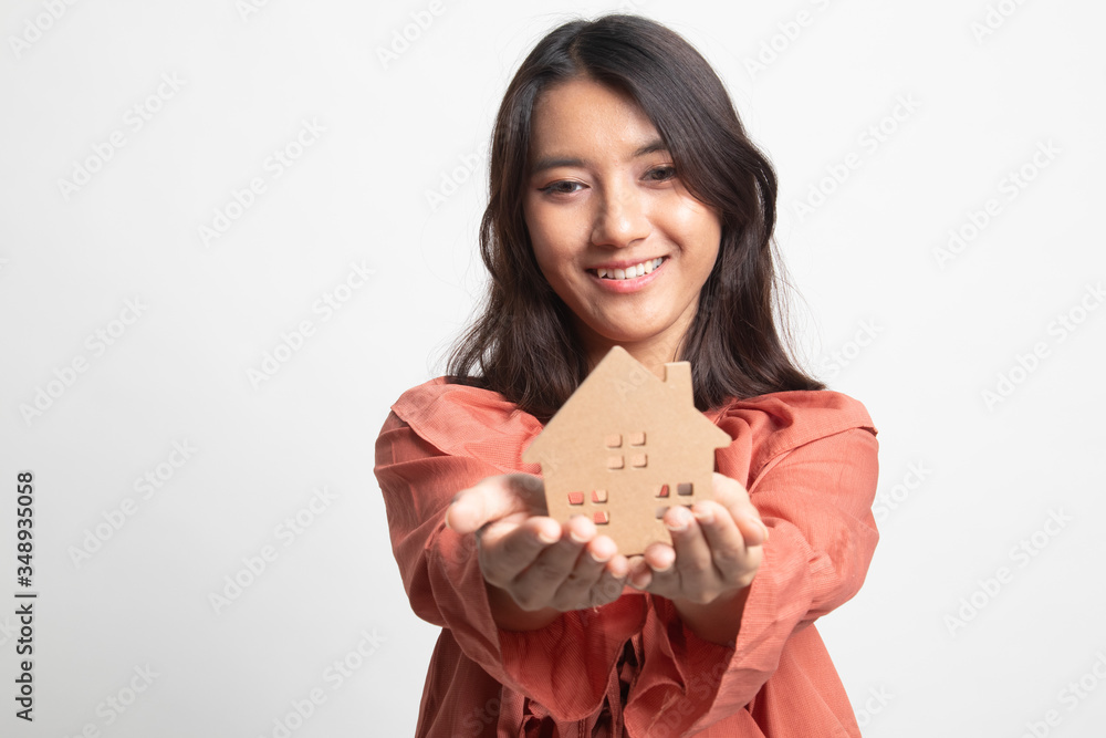 Happy young asian woman with house model . Happy young asian woman with house model .