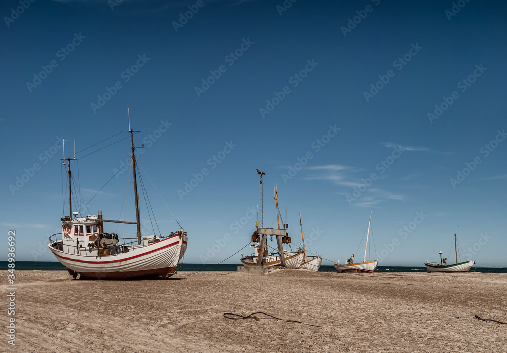 Coastal fishing boats on the beach at SletteStrand at the North Sea in Denmark