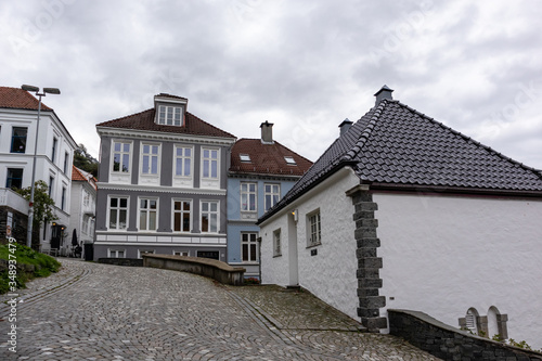 Cozy traditional scandinavian architecture on cobblestoned streets in Bergen, Norway. Moody cityscape