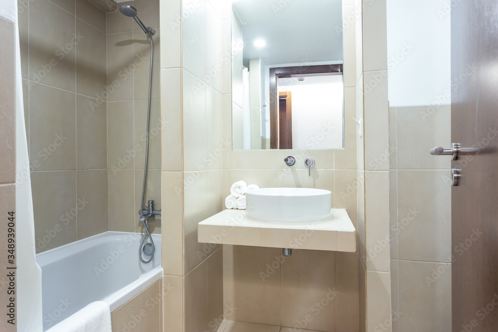 Modern bathroom with bathtub, mirror and washbasin. hotel design. Modern bathroom with bathtub, mirror and washbasin. hotel design.