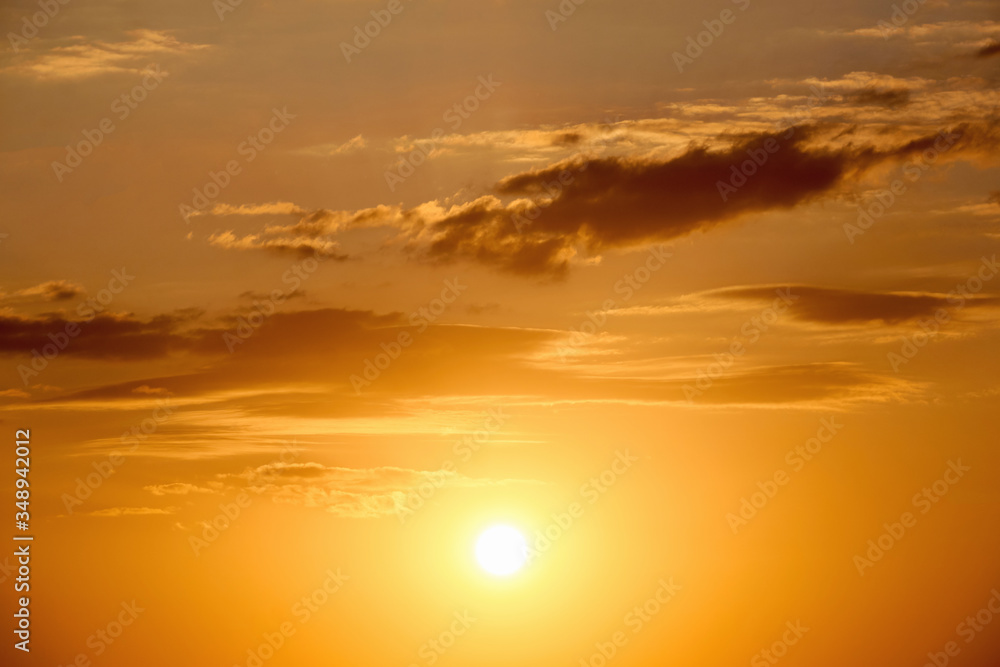 Beautiful landscape of orange evening sunset in the sky with clouds. The concept of the natural environment