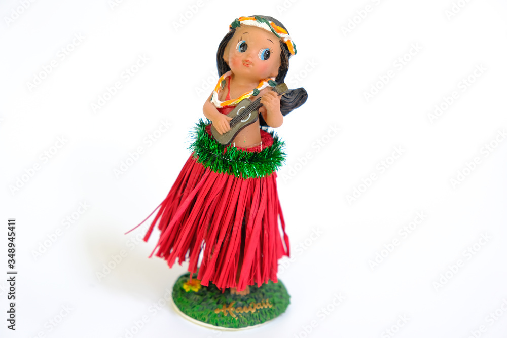 Hula dancer doll (girl) with ukulele on the white background Hula dancer doll (girl) with ukulele on the white background