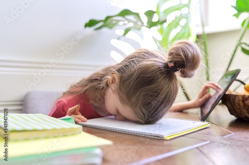 Εκτύπωση καμβά Tired girl student studying at home, girl in desperation laid her head on the ta