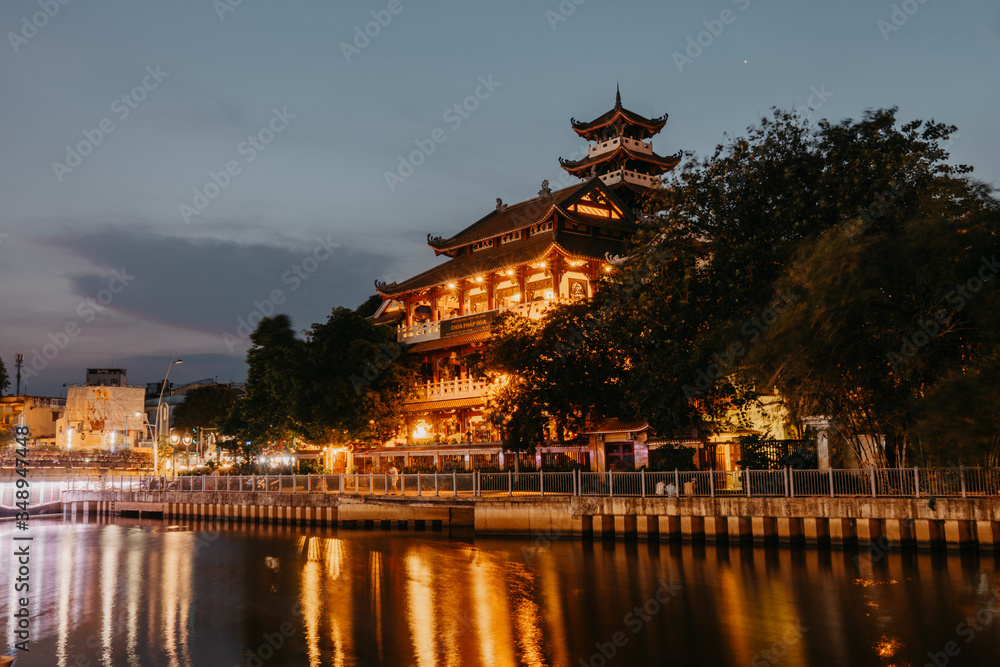 Night scene of Phap Hoa pagoda along Nhieu Loc canal (Saigon river) at night in Ho Chi Minh City, Vietnam Night scene of Phap Hoa pagoda along Nhieu Loc canal (Saigon river) at night in Ho Chi Minh City, Vietnam
