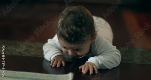 Cute baby development learning crawl on home floor. Adorable infant one year old portrait.