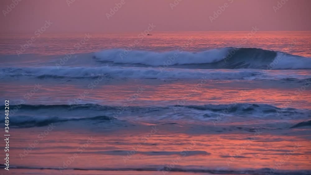 The waves of the ocean at sunset in a pink light The waves of the ocean at sunset in a pink light