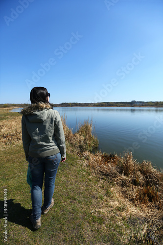 Portrait of a woman on the spring lake bank