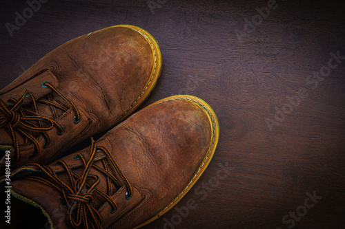 Old Dirty Brown Boots On Wooden Surface ,Flatlay top hiking retro watch 