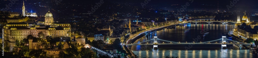 Panoramic of Budapest city skyline showing Buda Castle, Chain Bridge, Hungarian Parliament Building all reflecting on the Danube River