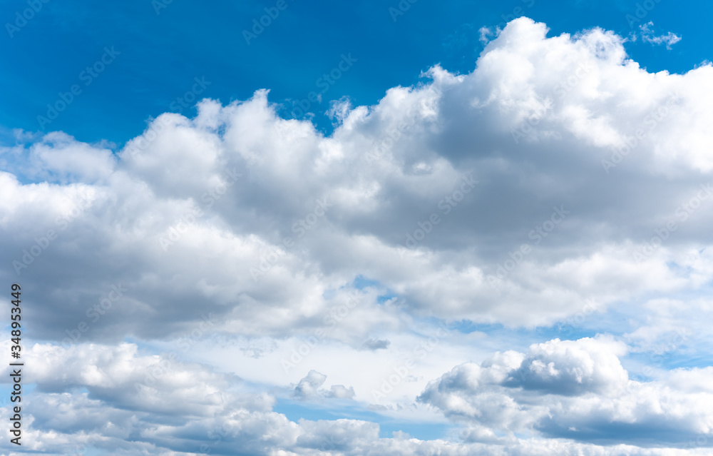 Obraz premium White clouds on the blue sky. Fluffy clouds background