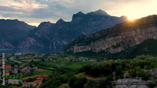 Panorama of Torbole a small town on Lake Garda, Italy. Europa, beautiful Lake Garda surrounded by mountains in the summer time at sunset