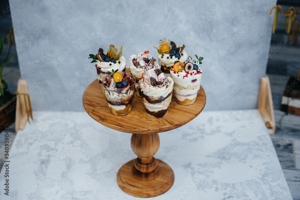 Naklejka premium Set of beautiful delicious trifl close - up on the background. Dessert and sweets