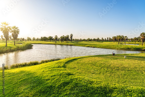 Canvas Print Beautiful, with green grass, golf course, with a pond, with sunny blue and clear sky