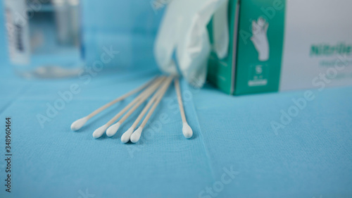 Swabs, disinfectant and gloves in a medical environment.