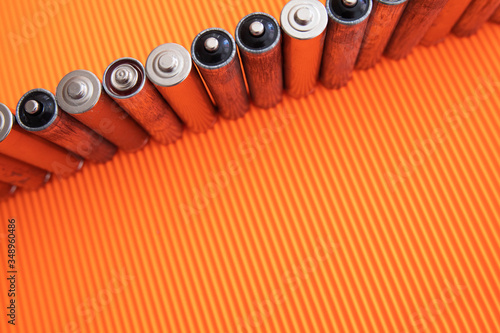 The silver aa batteries on an orange background