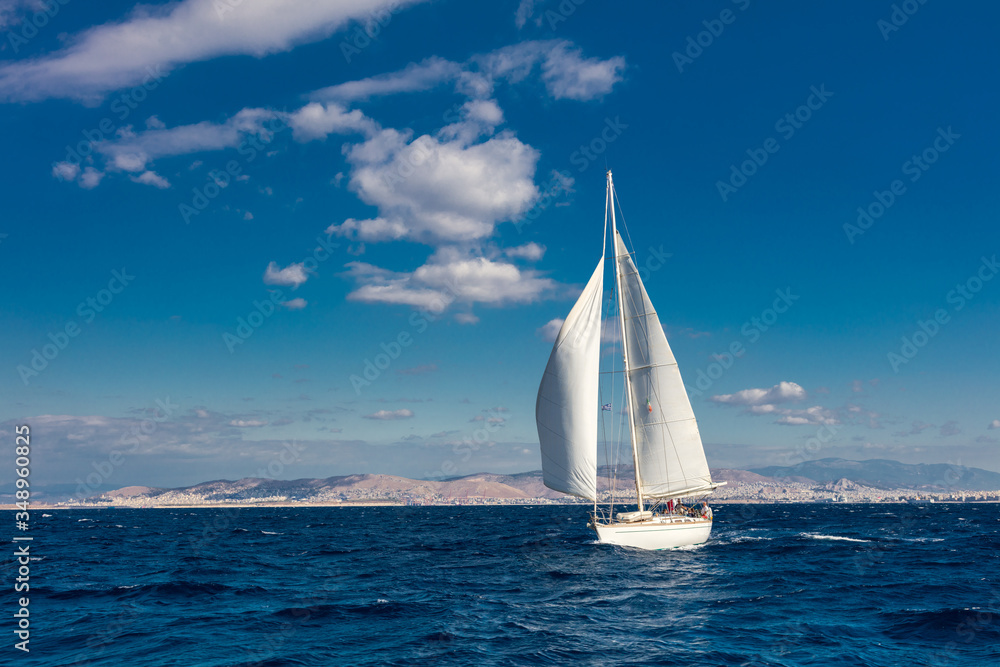 Beautiful White yacht sailing on a clear sunny day