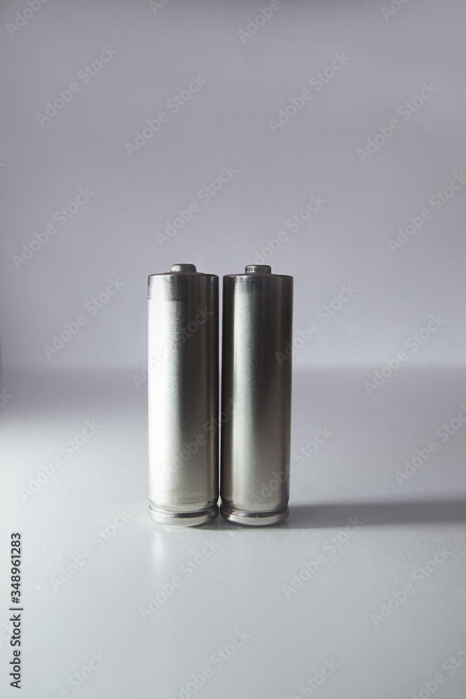 Two aa gray batteries on a white background Two aa gray batteries on a white background