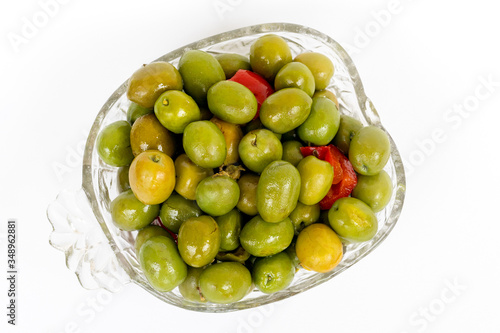 Obraz na płótnie Marinated olives in small transparent bowl. On white background. Pickled green olives w salonie