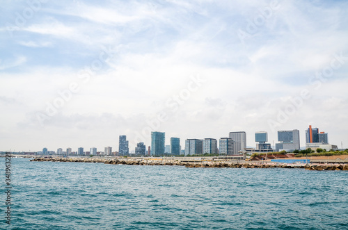 View from the sea in Spanish coastline and city of Barcelona with new architecture and modern buildings.