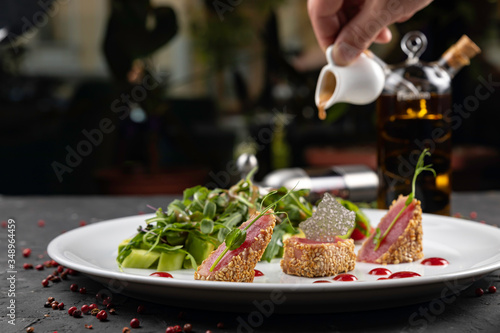 beautiful food: steak tuna in sesame, lime and fresh salad close-up on a plate on the table