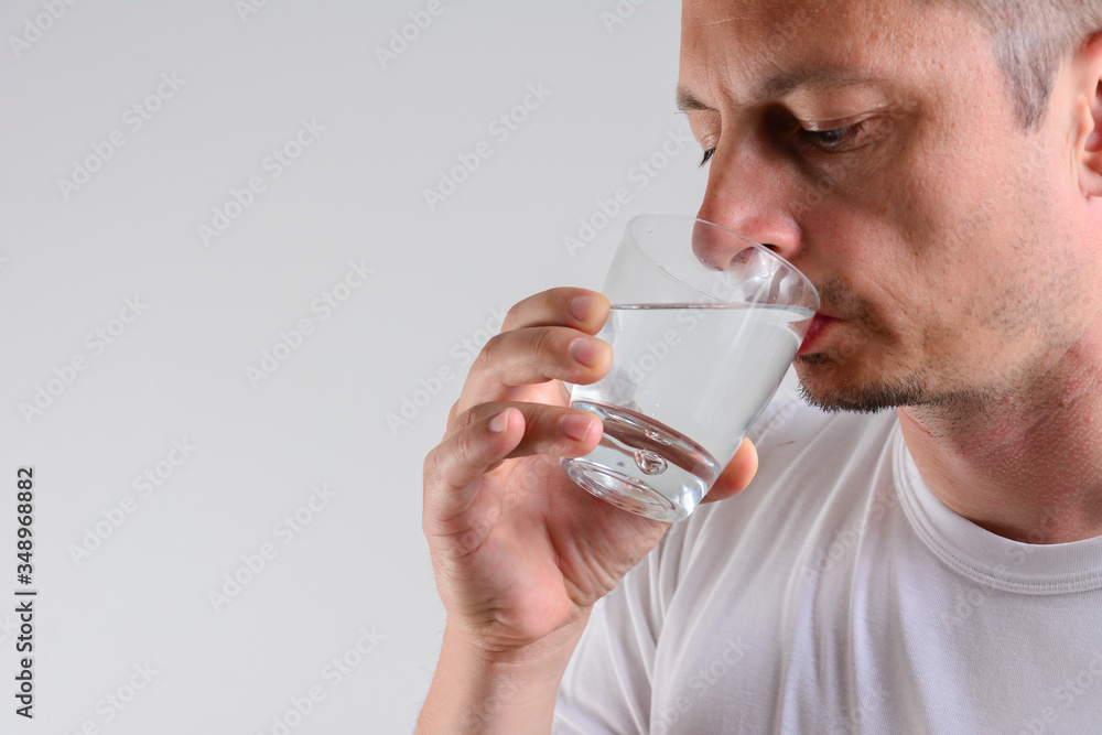Handsome Man Drinking Glass Of Fresh Water isolated on white background. Handsome Man Drinking Glass Of Fresh Water isolated on white background.