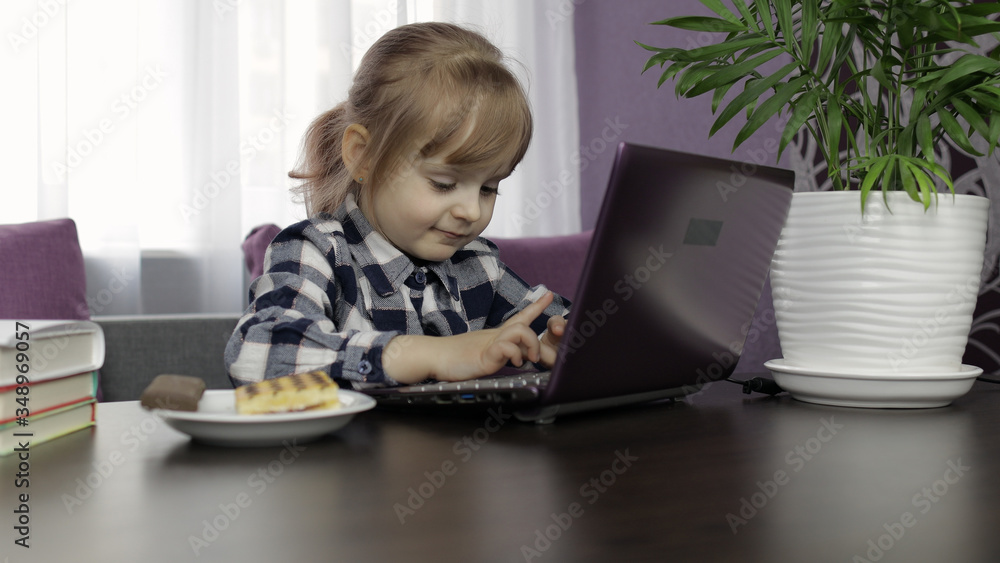 Girl doing lessons at home using digital laptop computer. Distance education Girl doing lessons at home using digital laptop computer. Distance education