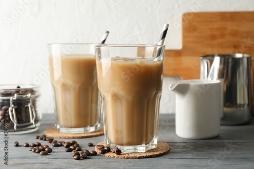 Composition with glasses of ice coffee on wooden background