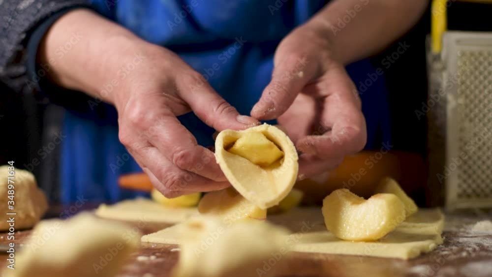 Close up of woman's hands make a apple pie. Slow Motion shot Close up of woman's hands make a apple pie. Slow Motion shot