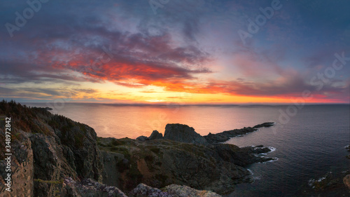 Beautiful vibrant sunset over a dramatic rugged coastline. Long Point Twillingate, Newfoundland Canada
