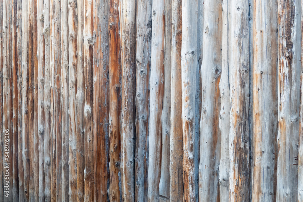 Wooden fence made of tree trunks. Background image. Wooden fence made of tree trunks. Background image.