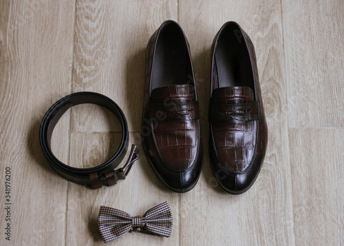 Wedding details. Groom accessories. Shoes, belt, and bowtie