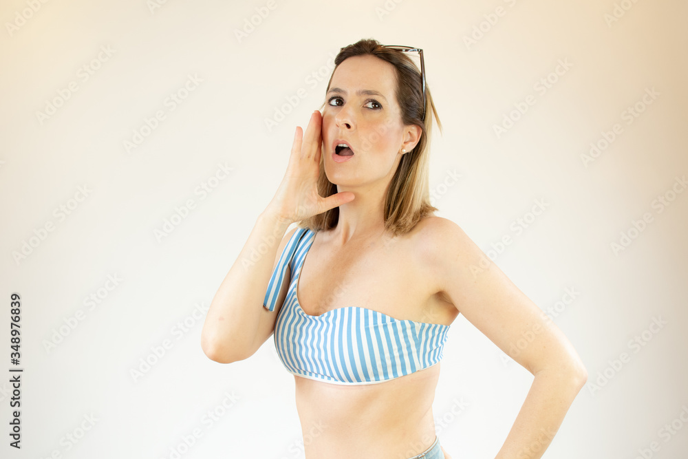 Beautiful woman wearing bikini is making speak up gesture Beautiful woman wearing bikini is making speak up gesture