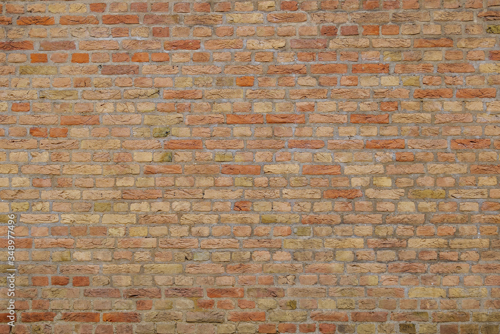 Naklejka premium Rough surface of yellow tone brick wall.