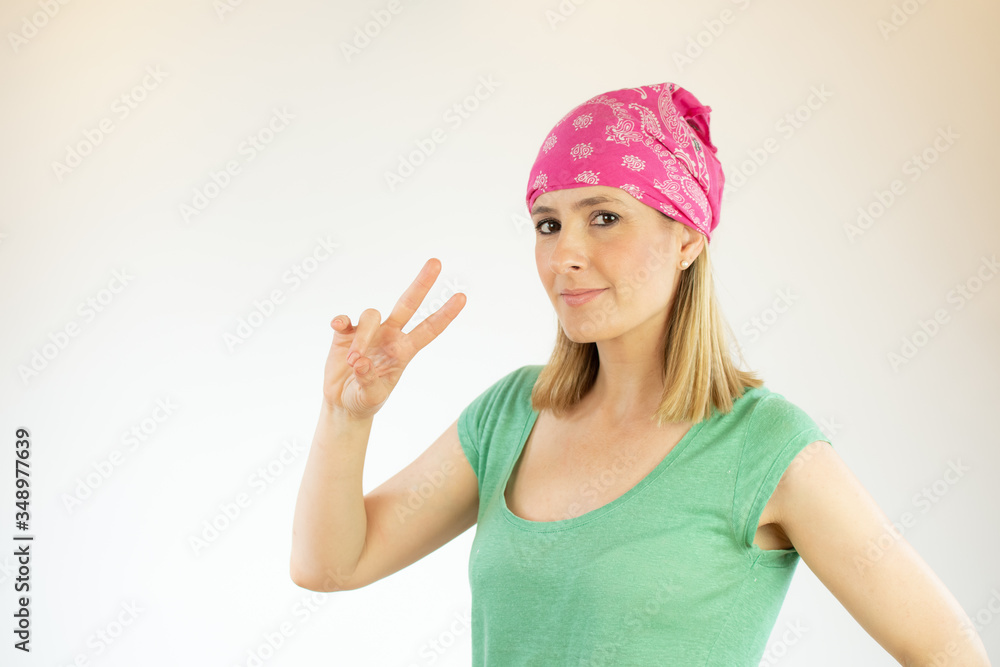 Young pretty woman wearing green shirt and making fingers up gesture Young pretty woman wearing green shirt and making fingers up gesture