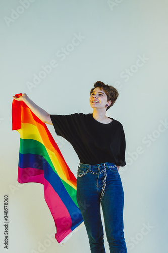 Beautiful lesbian girl holding a rainbow flag