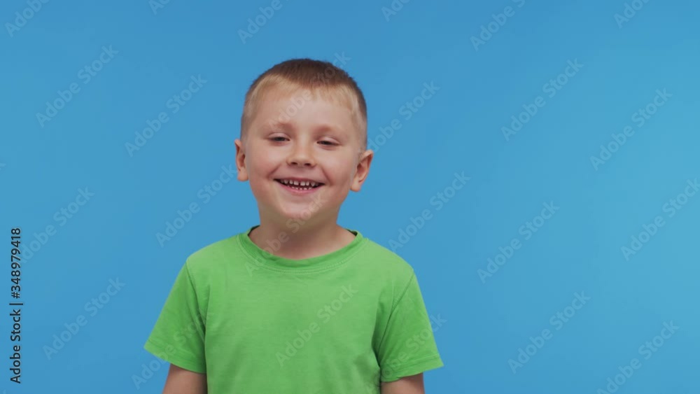 Portrait of happy smiling boy in t-shirt. Attractive and expressive kid in studio. Portrait of happy smiling boy in t-shirt. Attractive and expressive kid in studio.