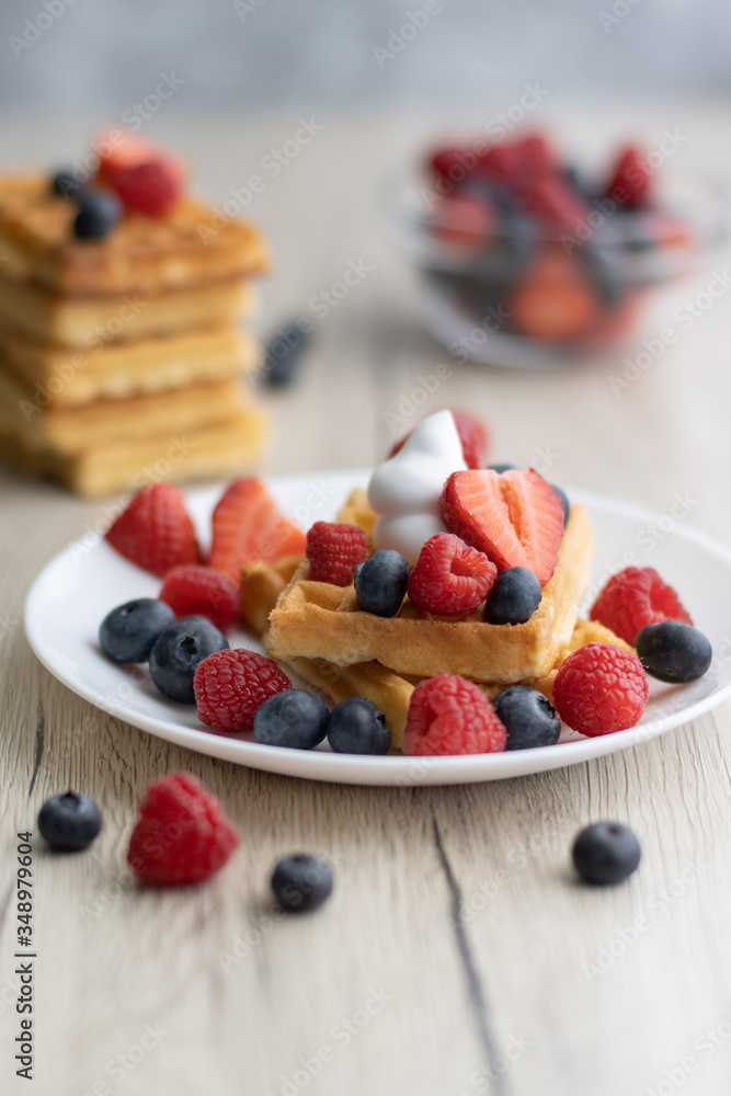 Belgian waffles with fresh fruit on wooden background Belgian waffles with fresh fruit on wooden background