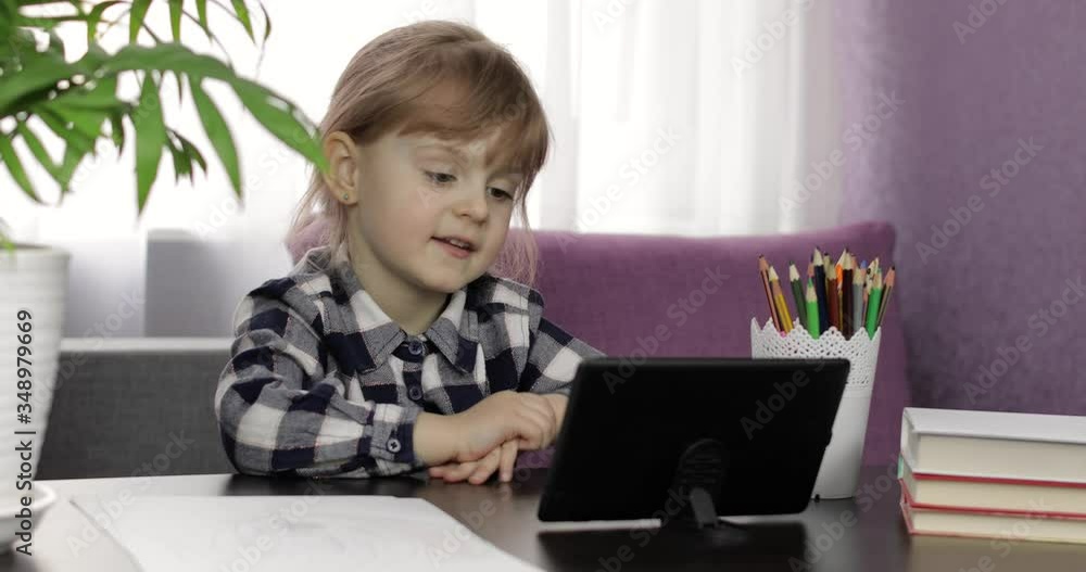 Girl doing online homework using digital tablet computer. Distance education