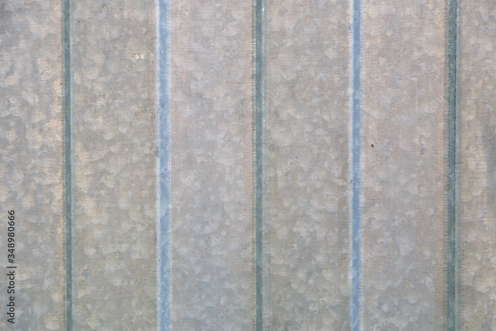 Fototapeta premium Background of corrugated gray metal sheet closeup