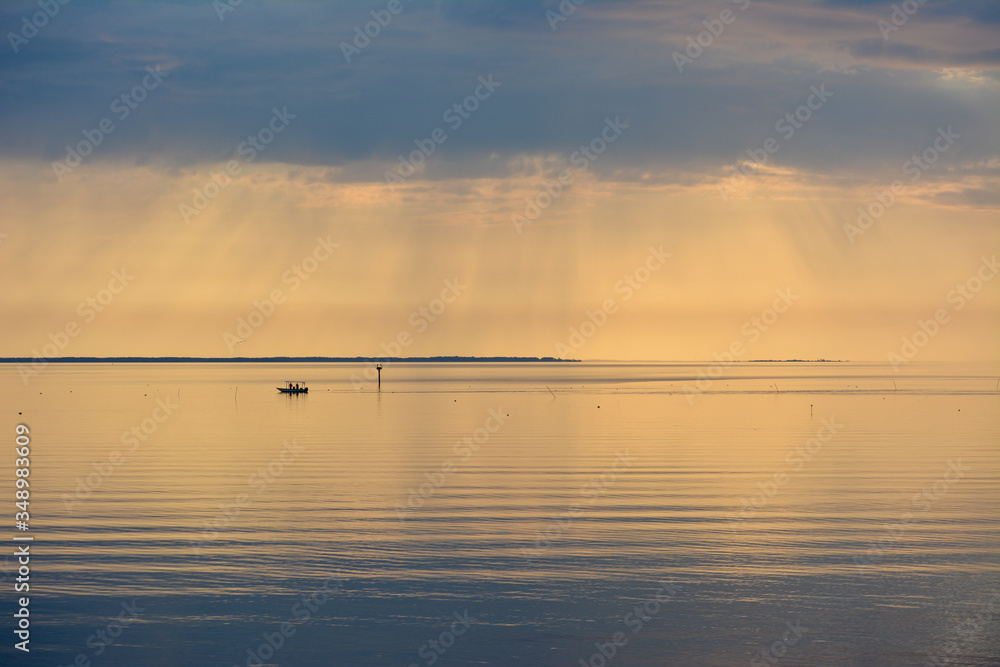 Fishing boat working crab pots during a beautiful sunrise over the Chesapeake Bay.