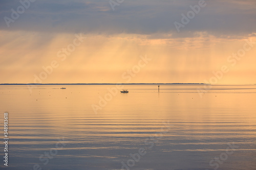 Two fishing boats checking crab pots during a beautiful sunrise on the Chesapeake Bay.