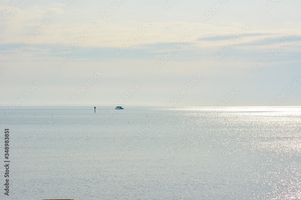 A fishing boat working crab pots on the Chesapeake Bay during a bright and sunny morning on the water. 