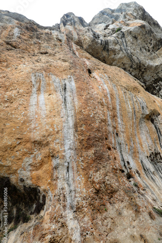 limestone cliff wall overlooking people photo